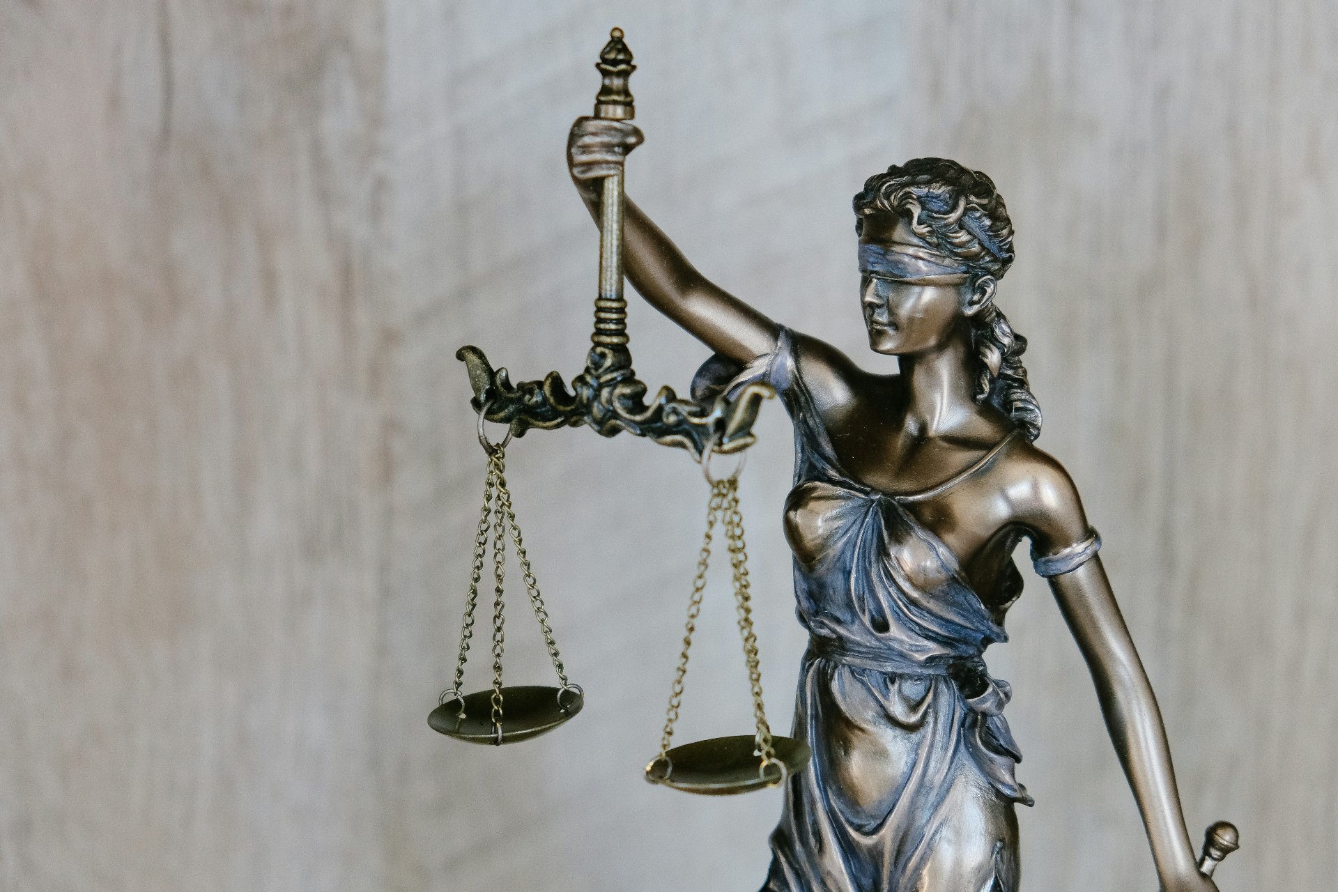 Bronze statue of Lady Justice holding scales